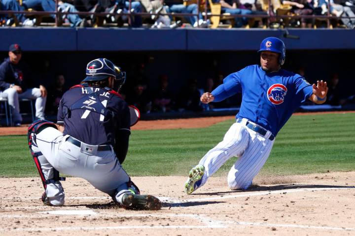 Chicago Cubs' Charcer Burks (54) slides into home plate during the annual Big League Weekend ba ...