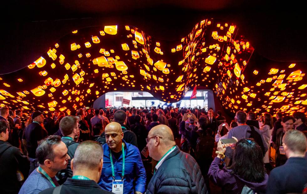 Attendees stream through the main entrance for Central Hall during CES Day 1 at the Las Vegas C ...