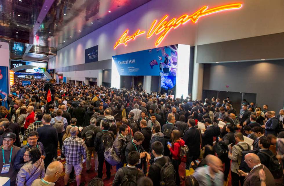 Attendees gather outside of the main entrance for Central Hall as CES Day 1 is about to open at ...