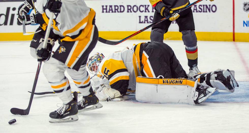 Pittsburgh Penguins goaltender Tristan Jarry (35) looks to the puck after turning away a Vegas ...