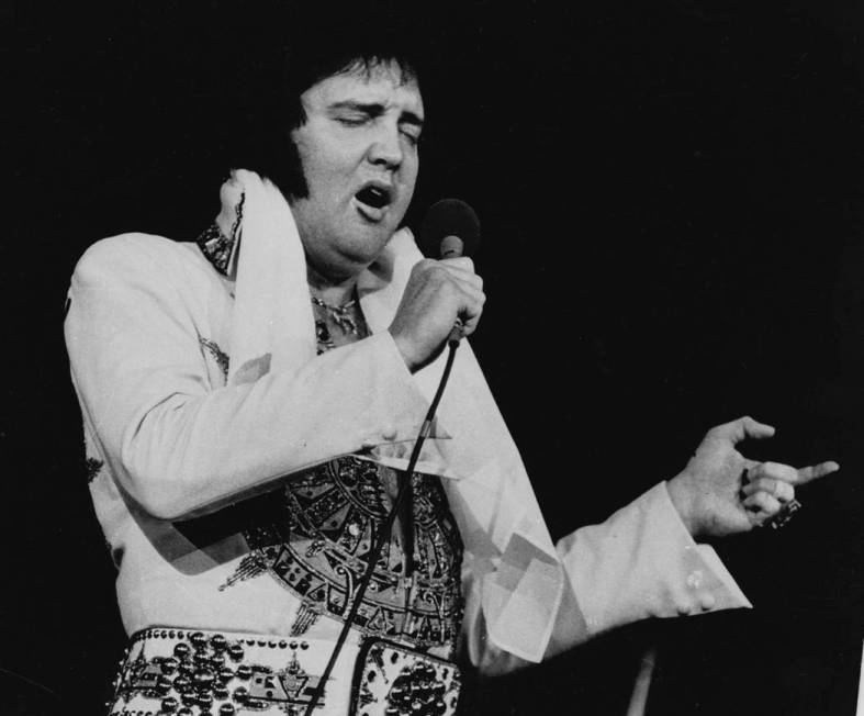 Elvis Presley performs during a concert in Providence, R.I. on May 23, 1977, three months befor ...