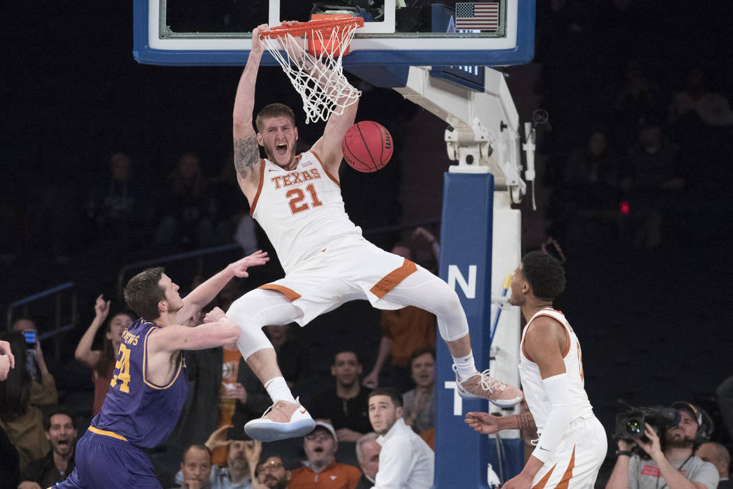 Texas forward Dylan Osetkowski (21) dunks during the second half of the championship basketball ...