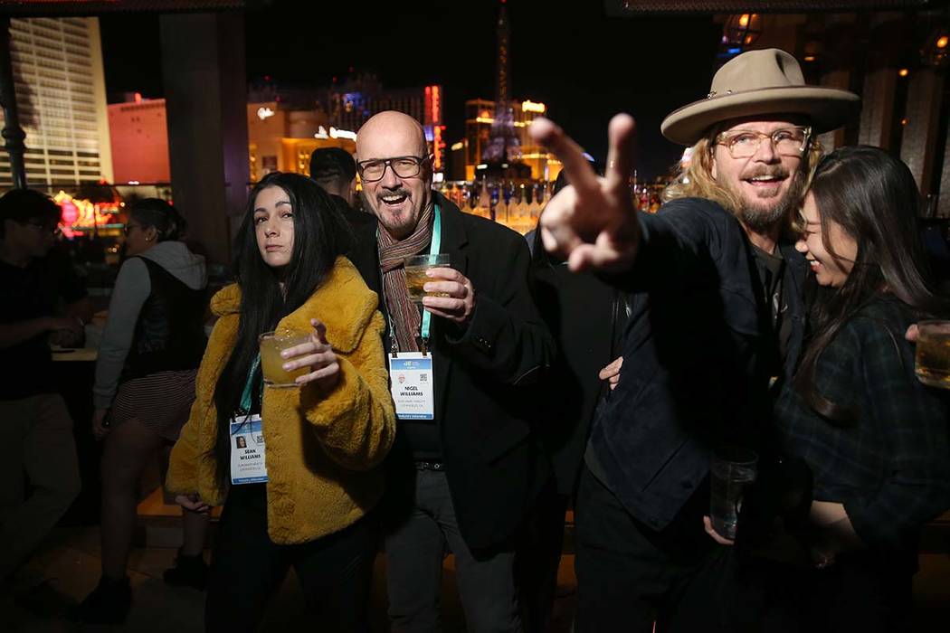 Conventioneers, including, from left, Sean Williams, Nigel Williams, both of Los Angeles, Gabri ...