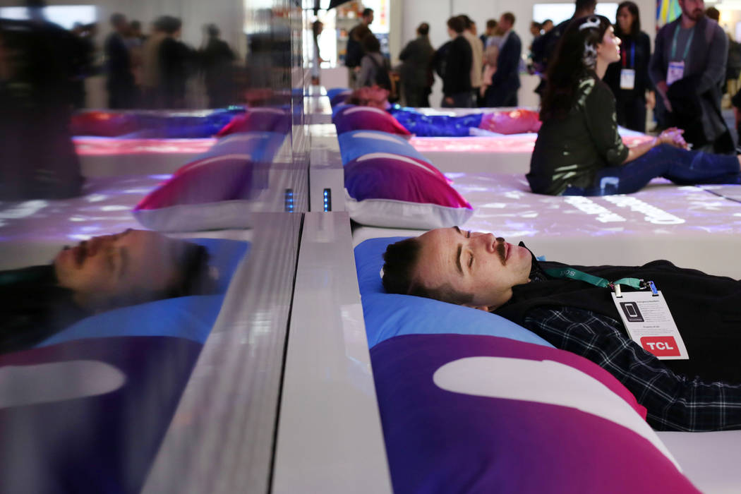 John Reynolds with Flexport lays on a CLIMATE360 Smart Bed by Sleep Number during the first day ...