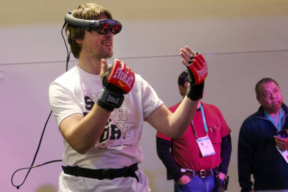 Sergii Dolgyi shows attendees how BotBoxer's workout program mixes virtual reality with a physi ...