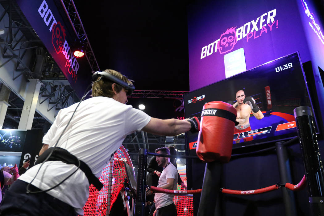 Sergii Dolgyi shows attendees how BotBoxer's workout program mixes virtual reality with a physi ...