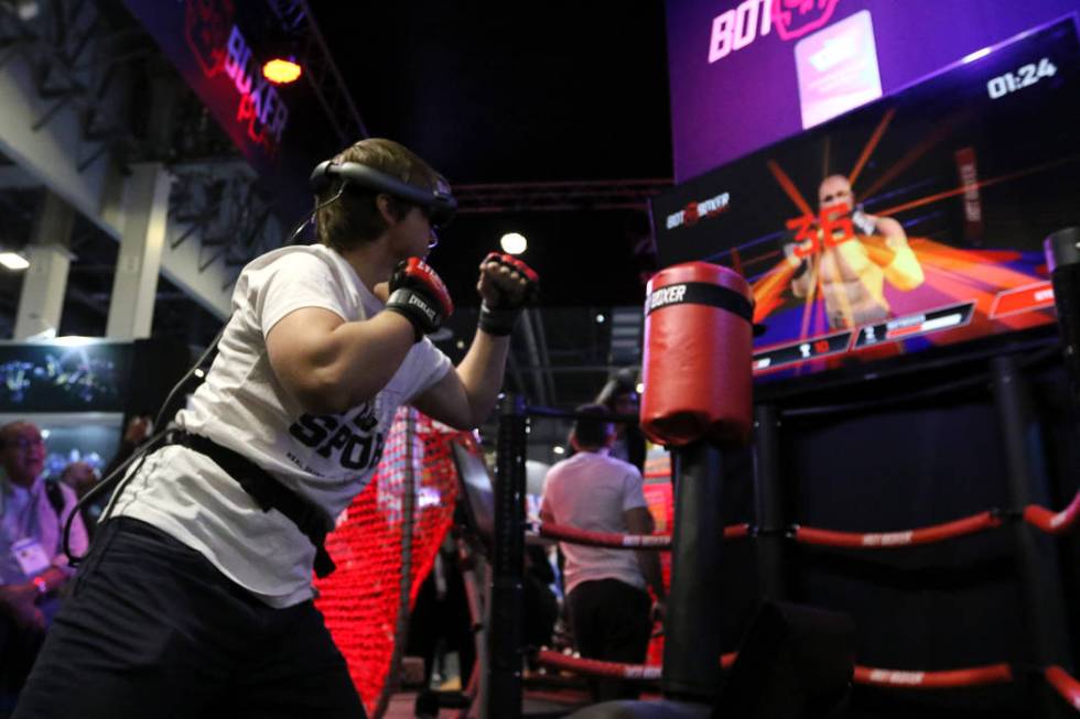 Sergii Dolgyi shows attendees how BotBoxer's workout program mixes virtual reality with a physi ...