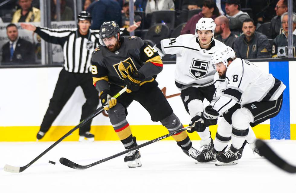 Golden Knights' Alex Tuch (89) battles for the puck against Los Angeles Kings' Nikolai Prokhork ...