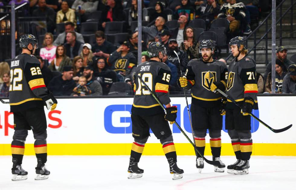 Golden Knights' Reilly Smith (19) talks with Chandler Stephenson, third from left, and William ...