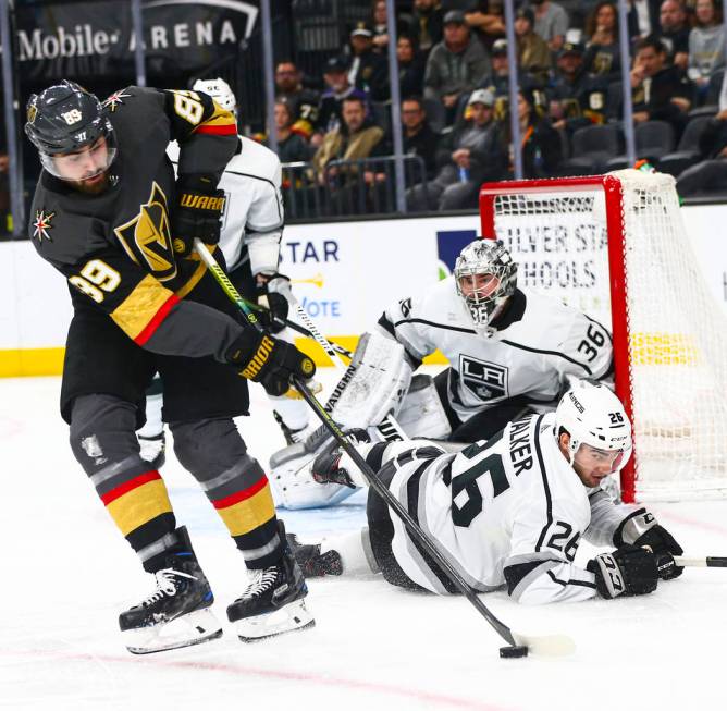 Golden Knights' Alex Tuch (89) moves the puck in front of Los Angeles Kings' Sean Walker (26) d ...