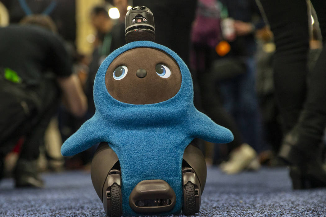 A Lovot robot by Groove X wanders the carpet about attendees during the "CES Unveiled Las ...