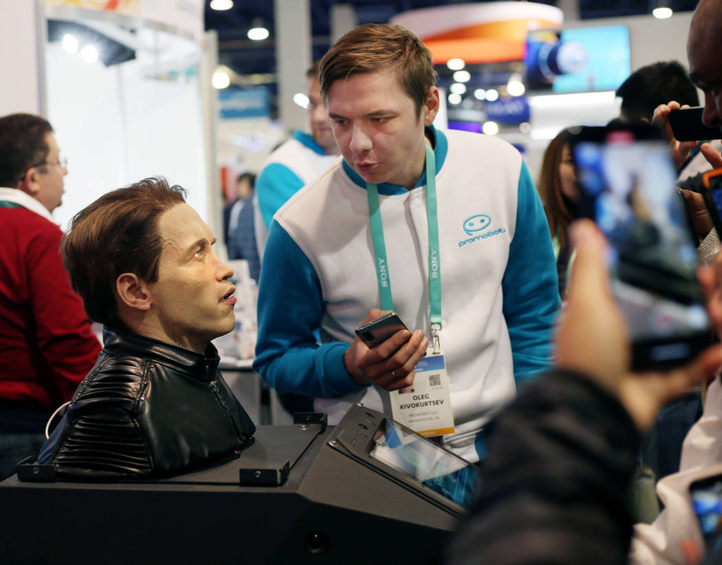 Promobot co-founder Oleg Kivokurtsev speaks to the animatronic bust of Arnold Schwarzenegger in ...