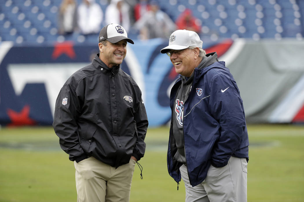 Baltimore Ravens head coach John Harbaugh, left, talks with Tennessee Titans defensive coordina ...