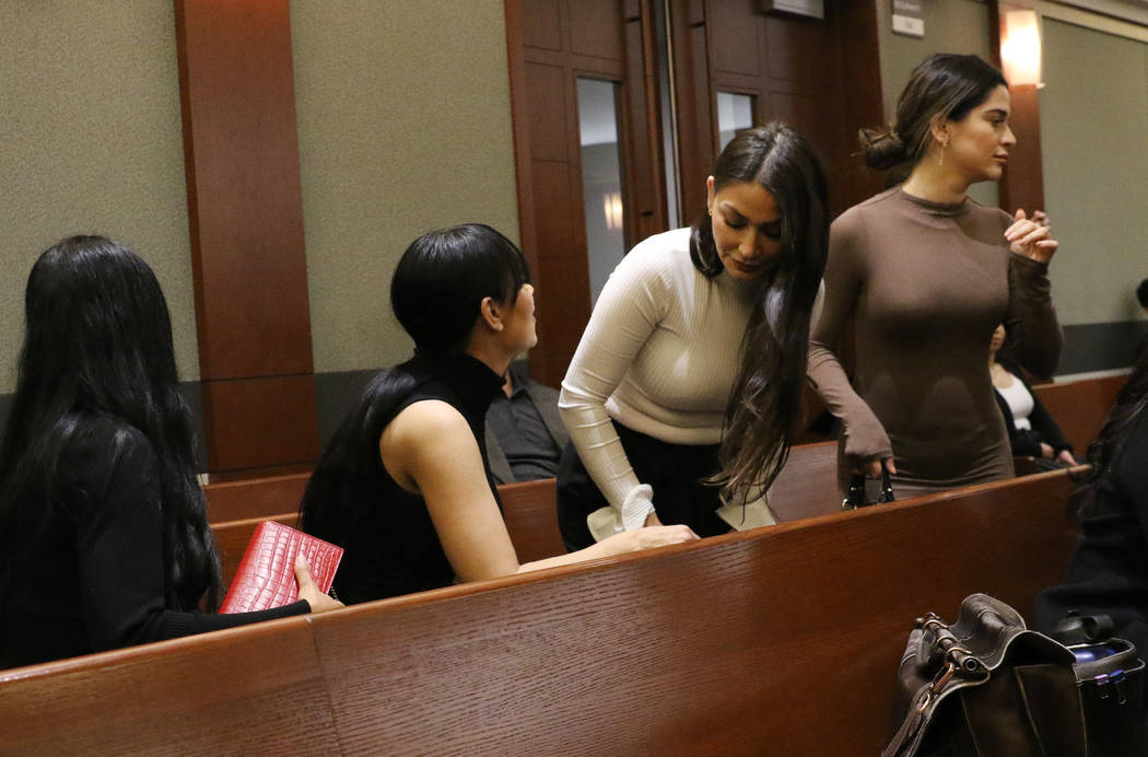 Four women, accused of an attack involving shoes at the Cosmopolitan, enter the courtroom durin ...