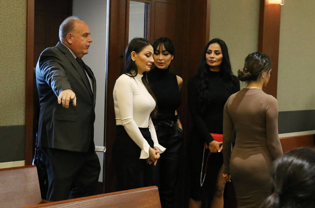 Four women, accused of an attack involving shoes at the Cosmopolitan, enter the courtroom with ...