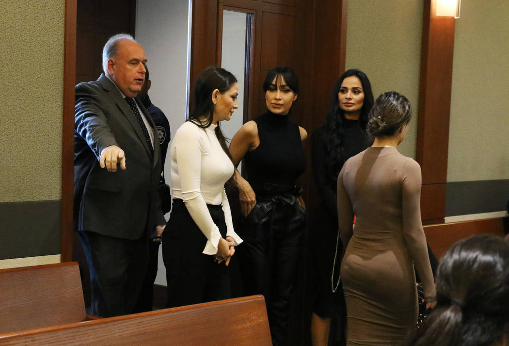 Four women, accused of an attack involving shoes at the Cosmopolitan, enter the courtroom with ...