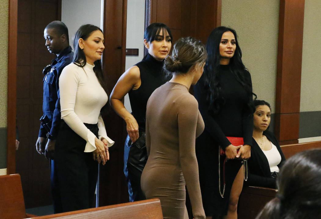 Four women, accused of an attack involving shoes at the Cosmopolitan, enter the courtroom durin ...