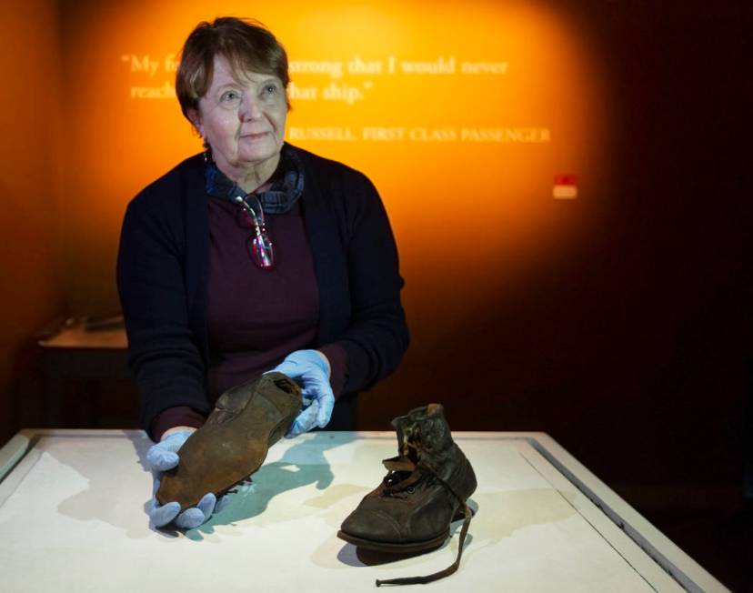 Alexandra Klingelhofer, executive director for collections, holds a pair of dress boots worn by ...