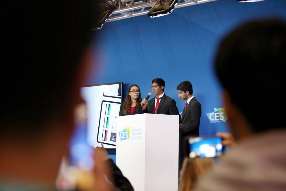 Southwest Career and Technical Academy students Elizabeth Wigington, left, Ishaan Raja, center, ...