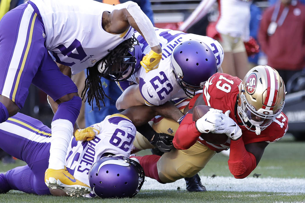 San Francisco 49ers wide receiver Deebo Samuel (19) is tackled by Minnesota Vikings cornerback ...