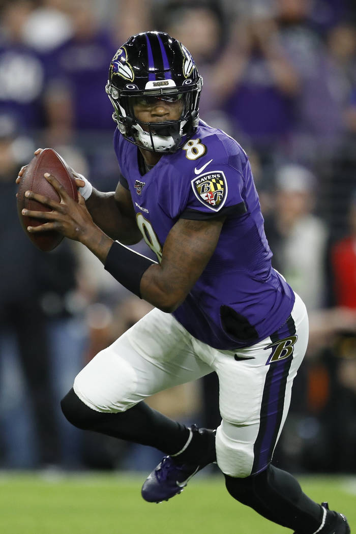 Baltimore Ravens quarterback Lamar Jackson (8) runs out of the pocket against the Tennessee Tit ...