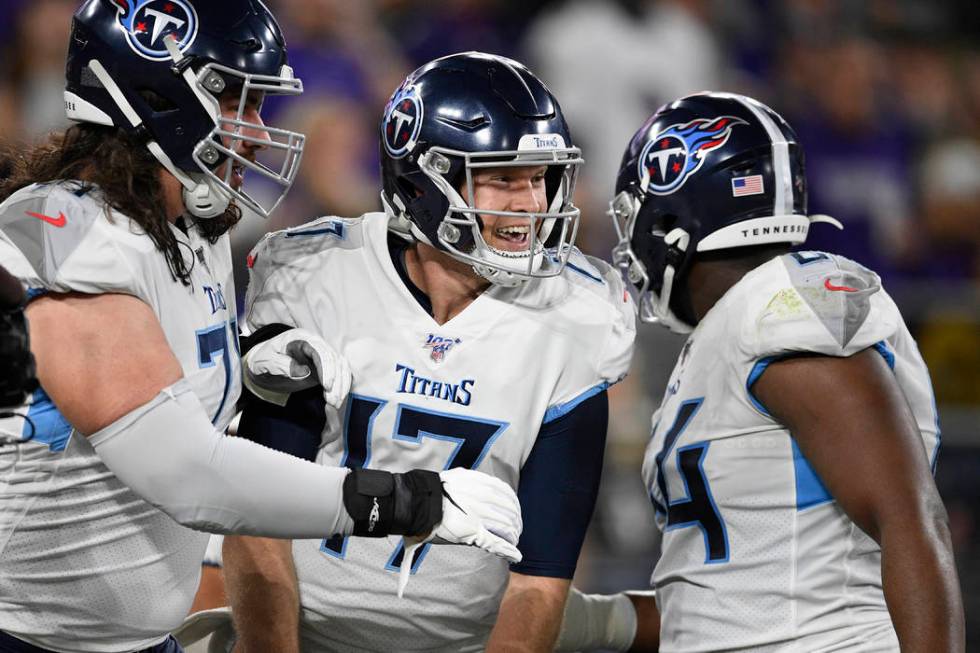 Tennessee Titans quarterback Ryan Tannehill (17) celebrates with teammates after a touchdown ag ...
