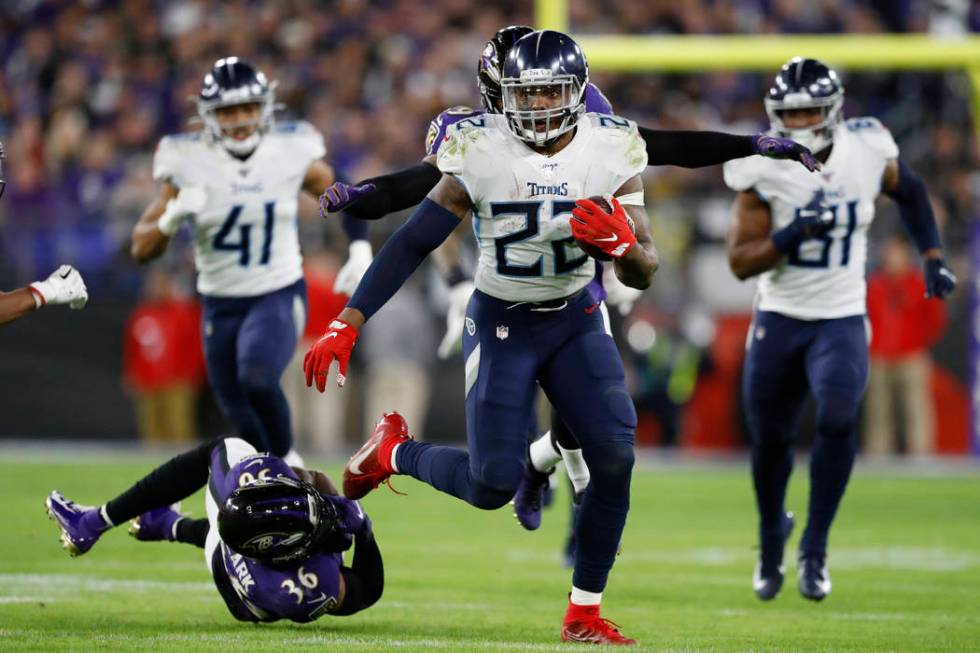 Tennessee Titans running back Derrick Henry (22) runs past Baltimore Ravens strong safety Chuck ...