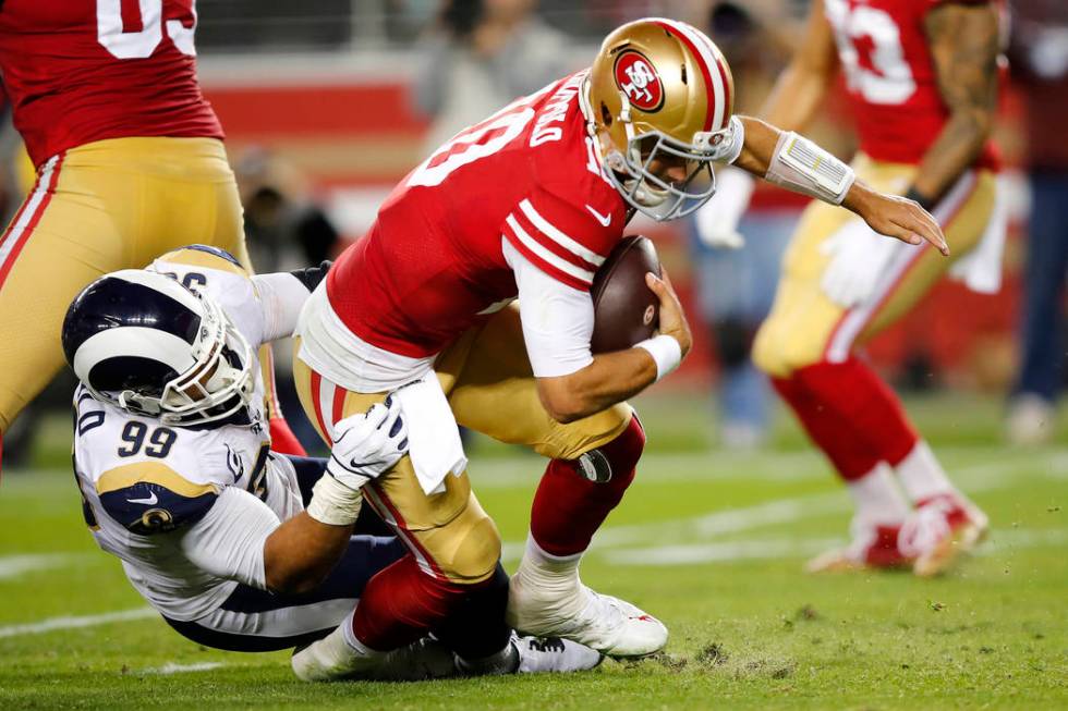 Los Angeles Rams defensive tackle Aaron Donald (99) sacks San Francisco 49ers quarterback Jimmy ...