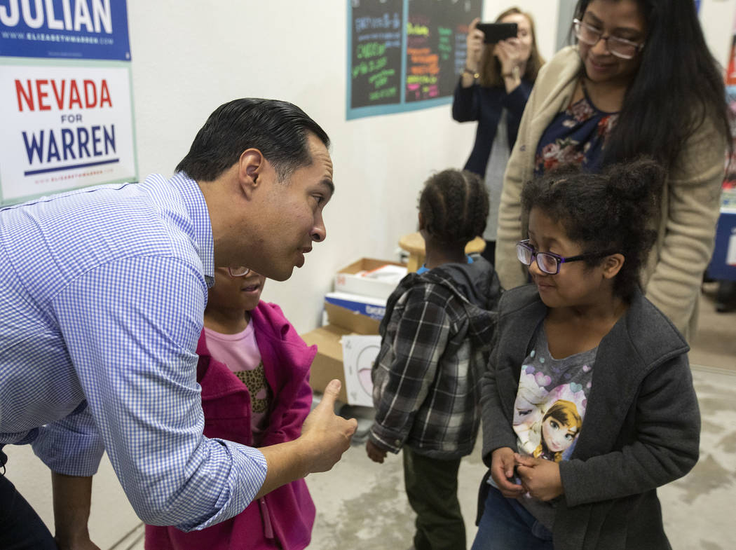 Julian Castro introduces himself to 6-year-old Scarlett Guigui, who came to hear the former pre ...