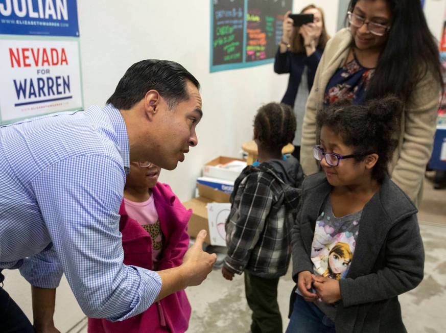 Julian Castro introduces himself to 6-year-old Scarlett Guigui, who came to hear the former pre ...