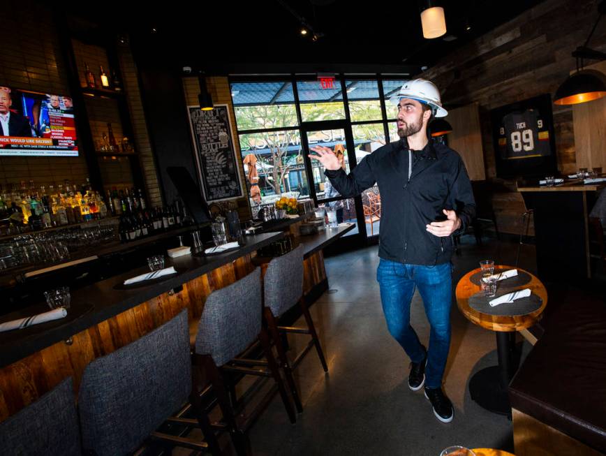 Golden Knights' Alex Tuch talks during a tour of the current Wolfgang Puck Bar & Grill spac ...