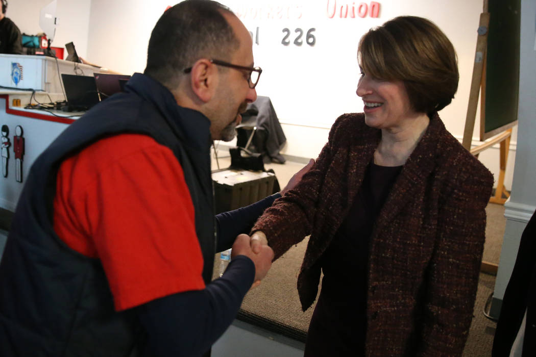 Democratic presidential candidate Amy Klobuchar, right, shakes hands with union member David Sa ...