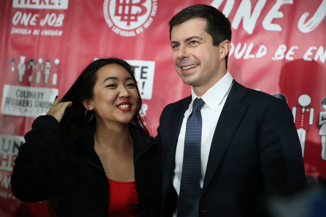 Democratic presidential candidate Pete Buttigieg, right, takes a photograph with union intern f ...