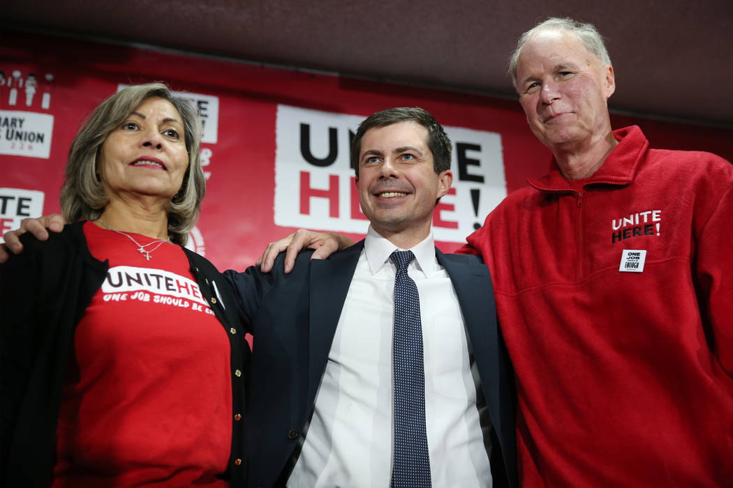 Democratic presidential candidate Pete Buttigieg, center, with Geoconda Arguello-Kline, left, s ...