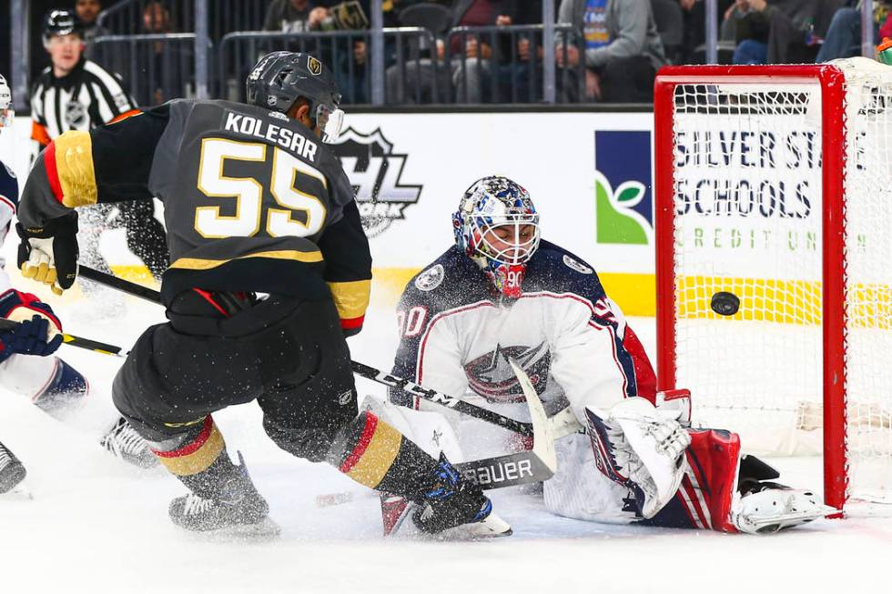 Columbus Blue Jackets' goaltender Elvis Merzlikins (90) blocks a shot from Golden Knights' Keeg ...