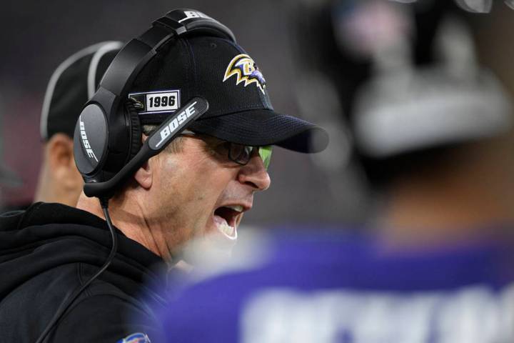 Baltimore Ravens head coach John Harbaugh speaks to players on ther sidelines during the first ...