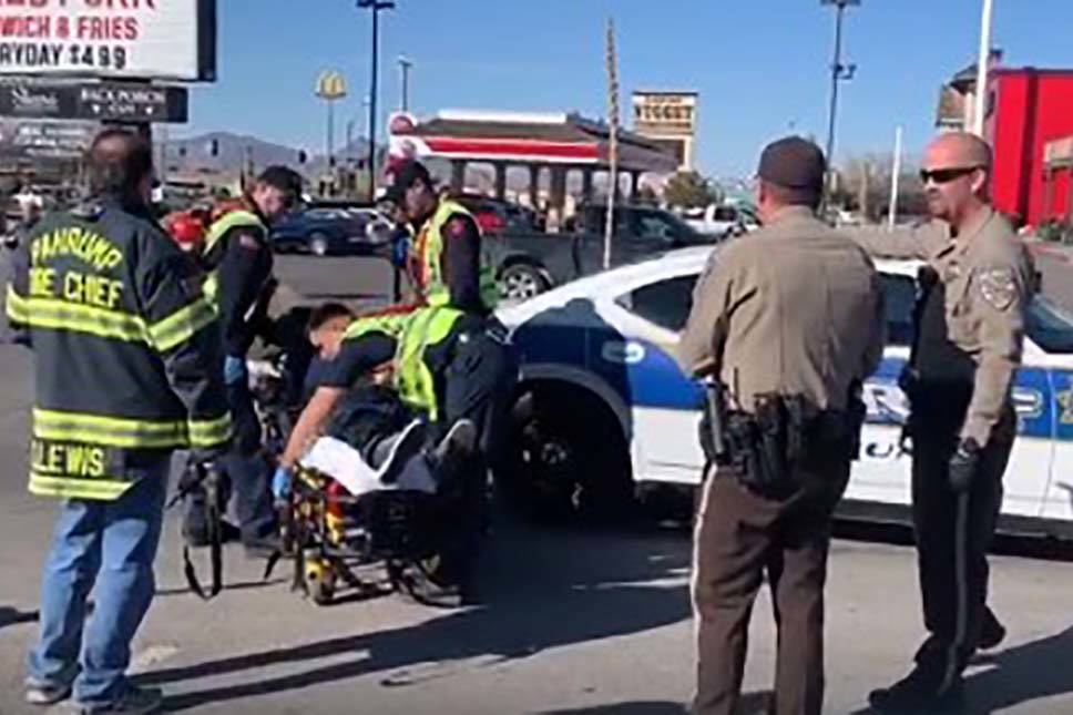 First responders attend to a Nye County Sheriff’s deputy who sustained minor injuries Saturda ...