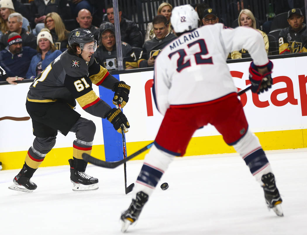 Golden Knights' Mark Stone (61) skates with the puck in front of Columbus Blue Jackets' Sonny M ...