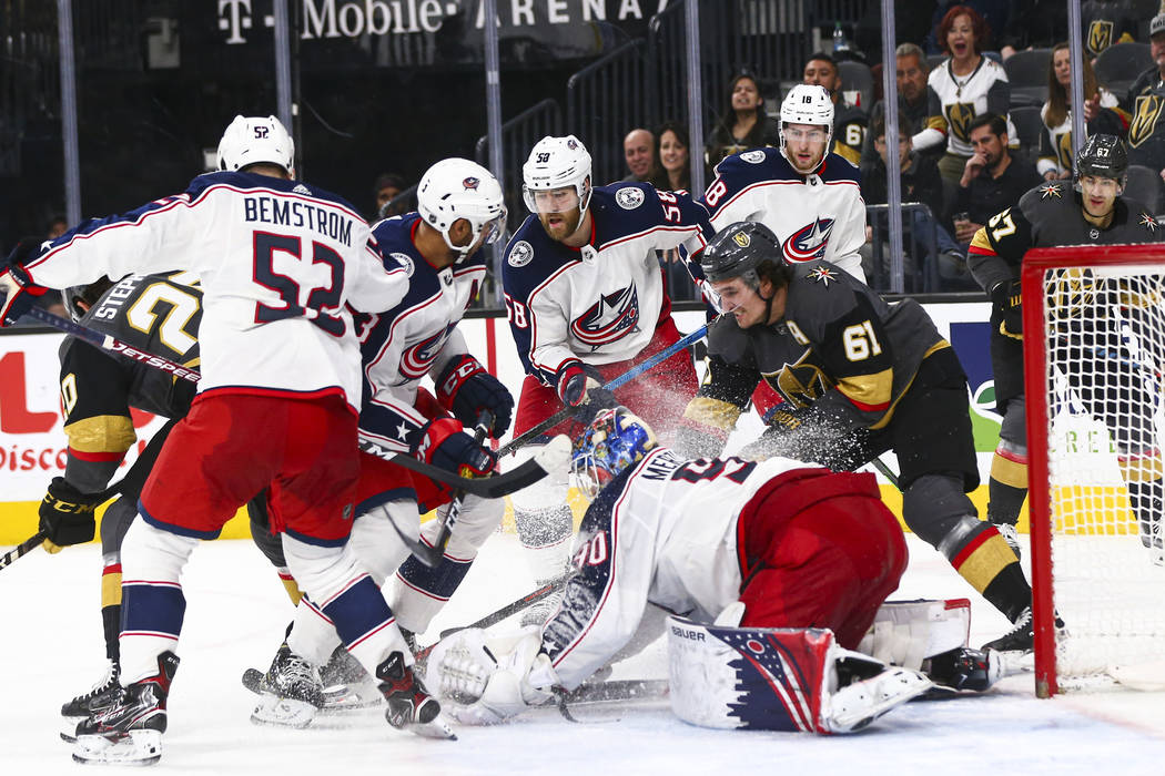 Columbus Blue Jackets goaltender Elvis Merzlikins (90) stops the puck in front of Golden Knight ...