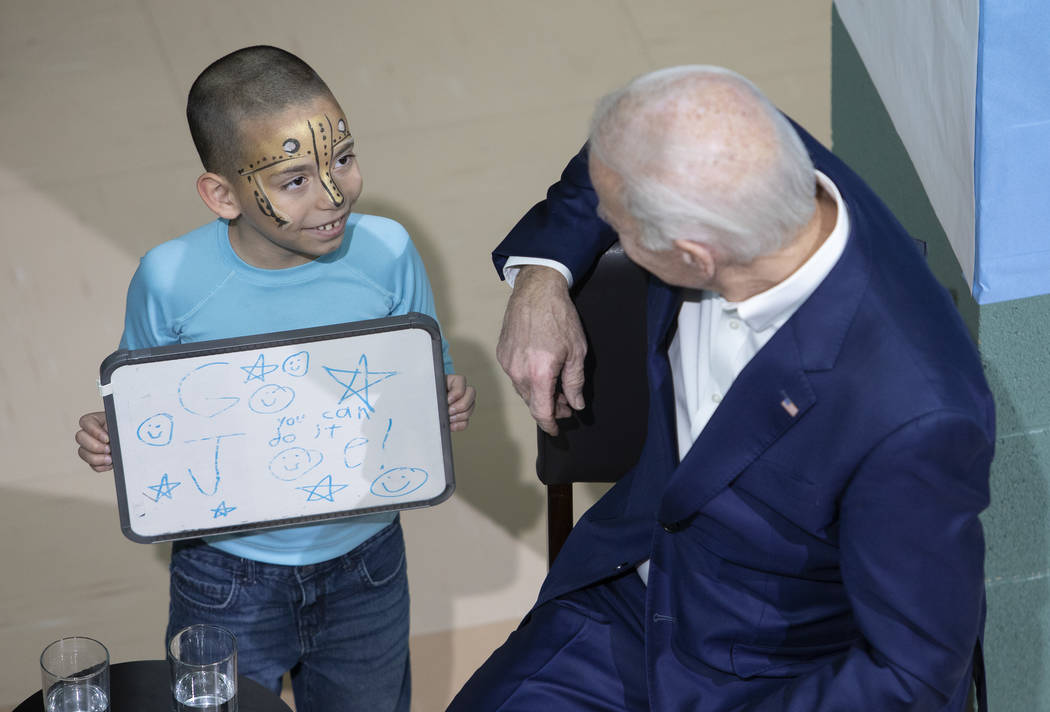 A young boy came up to presidential candidate Joe Biden right after he took the stage at a camp ...