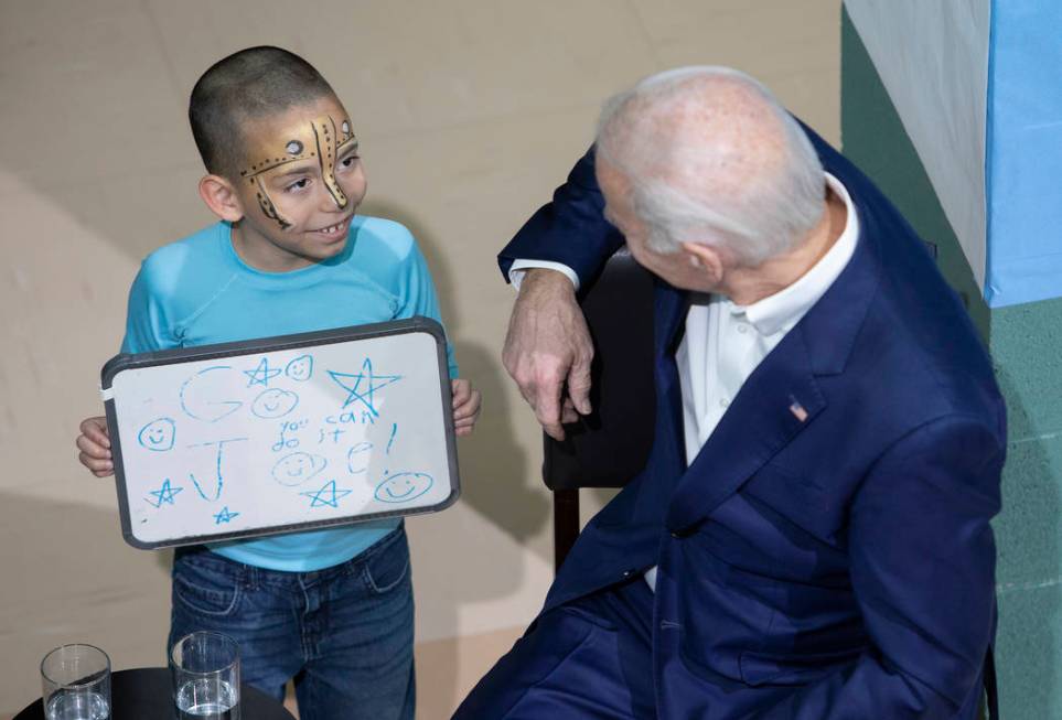 A young boy came up to presidential candidate Joe Biden right after he took the stage at a camp ...