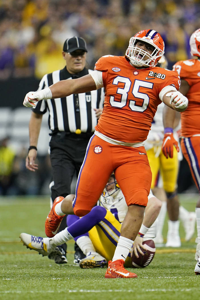 LSU quarterback Joe Burrow is sacked by Clemson defensive end Justin Foster during the first ha ...