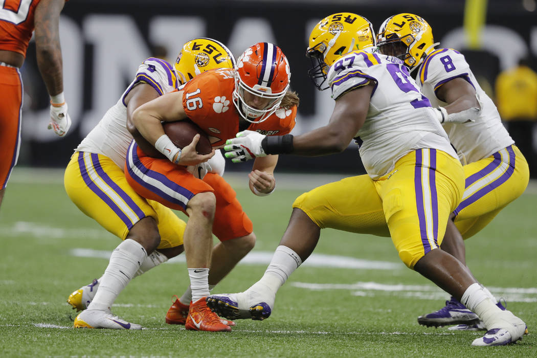 Clemson quarterback Trevor Lawrence gets sacked by LSU during the second half of a NCAA College ...