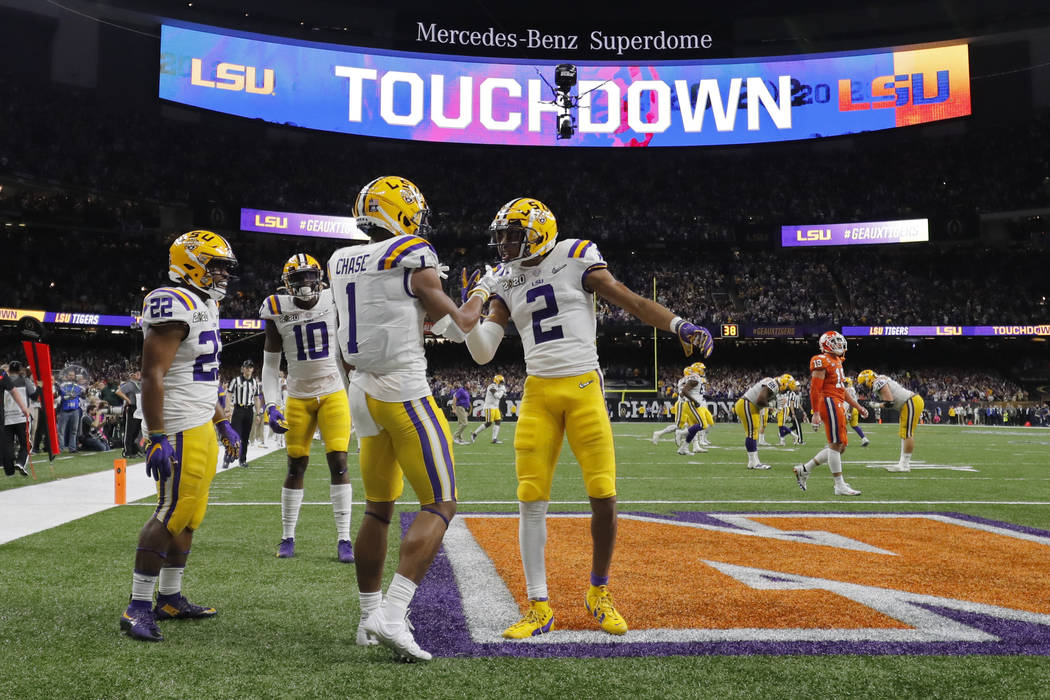LSU wide receiver Ja'Marr Chase (1) celebrates after scoring with wide receiver Justin Jefferso ...