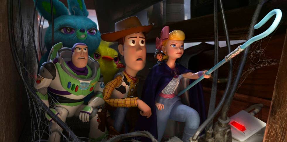 This image released by Disney shows, foreground from left, Buzz Lightyear, voiced by Tim Allen, ...