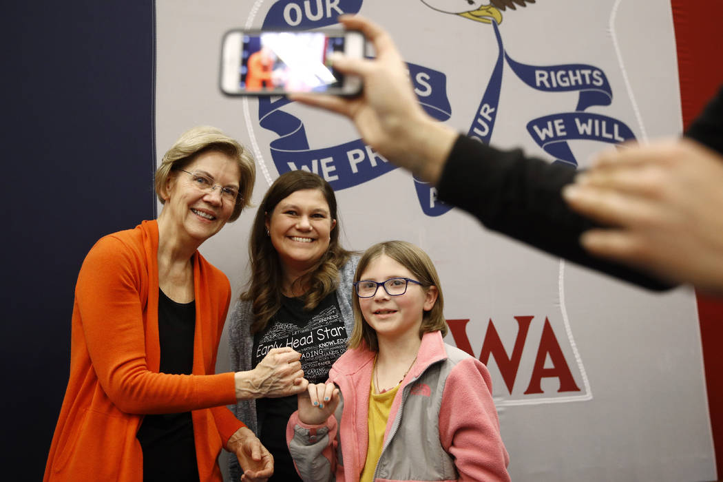 Democratic presidential candidate Sen. Elizabeth Warren, D-Mass., left, poses for a photo with ...