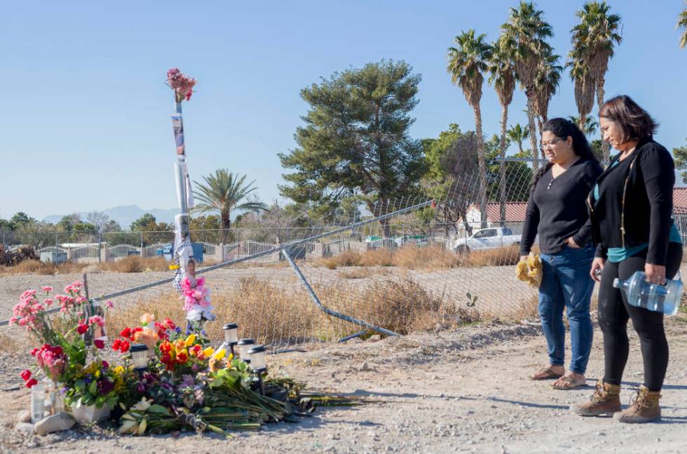 Sisters Andrea Lopez, left, and Ruth Neall look at the memorial on Monday, Jan. 13, 2020, at th ...