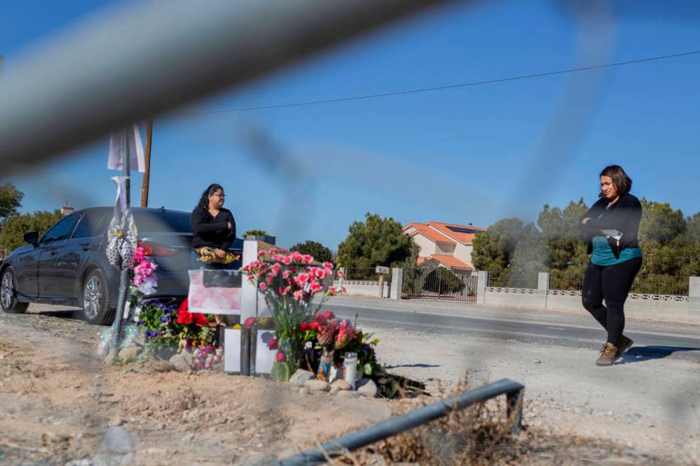 Sisters Andrea Lopez, left, and Ruth Neall look at the memorial on Monday, Jan. 13, 2020, at th ...