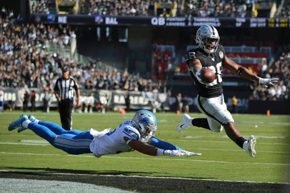 Oakland Raiders running back Josh Jacobs (28) runs for a touchdown past Detroit Lions defensive ...