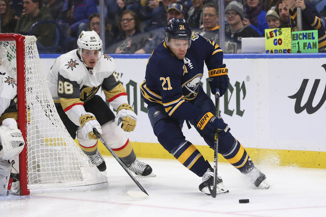 Buffalo Sabres forward Kyle Okposo (21) carries the puck past Vegas Golden Knights defenseman N ...